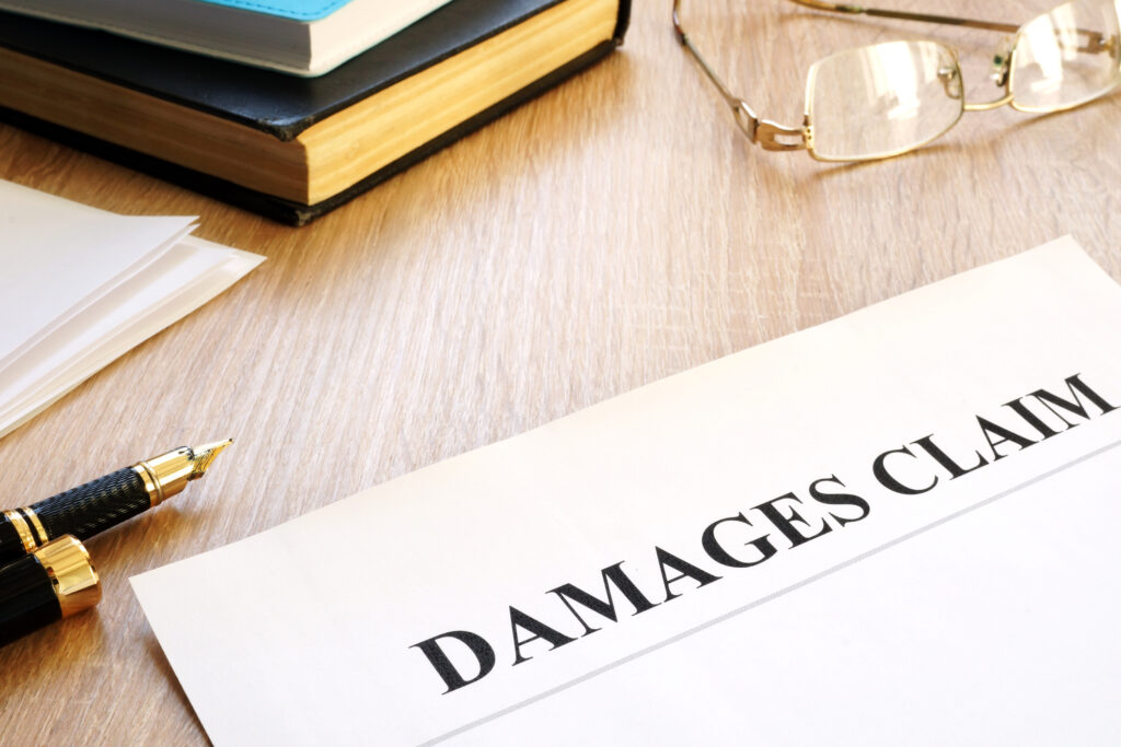 Damages claim form and pen. Insurance concept.